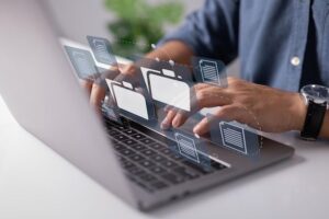 Paperless in the office worked on the laptop computer keyboard with electronic document icons displayed on the virtual screen _ Premium Photo